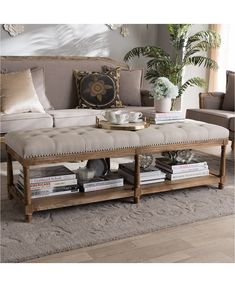 a living room with a couch, coffee table and bookshelf on the floor