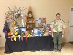 a man standing in front of a table with plaques and awards on it's sides