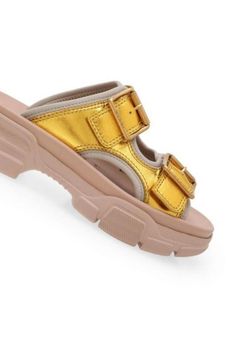 These Gucci leather sandals make a casual essential that's elevated with an outdoor-inspired vibe. This slide-sandal hybrid is designed with metallic double leather straps, a technical canvas lining, and a chunky, oversized rubber sole.Open toeBuckle fasteningChunky heel.Composition: Calf Leather 100%, Polyamide 100%Lining: Polyamide 100%, Polyurethane 100%Sole: Rubber 100%Made in Italy Luxury Summer Slides With Buckle Closure, Casual Gold Slides With Buckle Closure, Leather Chunky Platform Slip-on Sandals, Leather Slide Sandals For Streetwear, Designer Summer Slides With Buckle Closure, Luxury Leather Platform Slides, Gucci Sandals With Buckle Closure And Open Toe, Gucci Open Toe Sandals With Buckle Closure, Luxury Slides With Textured Footbed For Spring