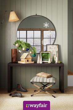 a living room with a mirror, ottoman and christmas decorations on the table in front of it