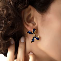 We are so happy to introduce this incredibly beautiful new style. Truly feminine, graceful and elegant earrings to pair up with both your day and evening wear. These gleaming earrings are handmade with 22K gold plated brass and enamel. There are clear zircon stones in the middle of the bow. These nickel free earrings are for pierced ears. They come as a pair with both butterfly and silicone earring backs. These beautiful earrings come with the Milou Jewelry box For avoiding damage to your jewels Elegant Gold Clip-on Earrings For Celebration, Elegant Blue Drop Clip-on Earrings, Elegant Blue Earrings For Anniversary, Luxury Gold Plated Clip-on Earrings For Evening, Luxury Blue Earrings For Party, Elegant Blue Jewelry For Evening, Luxury Blue Party Earrings, Glamorous Blue Evening Earrings, Blue Elegant Evening Jewelry