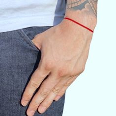 Embrace simplicity and good fortune with our Lucky Red String Bracelet. This minimalist accessory is more than just a fashion statement; it's a symbol of protection, good karma, and energy shielding. Crafted for both casual and sporty wear, it's perfect for daily use. The vibrant red hue not only adds a touch of color to any outfit but also serves as a talisman for attracting good luck and warding off negative energies. Adjustable Red Bracelets For Everyday, Casual Red Friendship Jewelry, Red Casual Wristband As Gift, Casual Red Jewelry For Friendship, Casual Red Wristband As Gift, Casual Red Wristband For Gift, Red Adjustable Bracelets For Everyday, Modern Red Everyday Jewelry, Modern Red Jewelry For Everyday