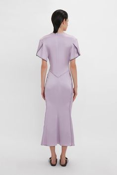 Elegant midi dresses are a hallmark of the Victoria Beckham brand. Crafted in a figure-flattering stretch fabric, this V-neck midi dress in romantic Petunia has a soft curved neckline and waist-defining pleat detail. Draped short sleeves with exposed seams and contrasting navy topstitching inject directional talking points, while a longer-length hem to the back enhances the fluidity of this modern classic. Victoria Beckham Gathered V-Neck Midi Dress In Petunia  - Size 12 UK Elegant V-neck Midi Dress For Daywear, Spring Formal Midi Dress With Structured Boning, Elegant Fitted V-neck Dress For Daywear, Fitted Midi Dress With Bias Cut For Dinner, Elegant Fitted Silk Daywear Dress, Fitted Maxi Length V-neck Dress For Daywear, Fitted Bias Cut Midi Dress For Dinner, Elegant Fitted Silk Dress For Daywear, Fitted Bodice Midi Dress With Bias Cut