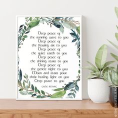 a watercolor wreath with the words on it next to a potted green plant