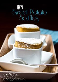 two desserts sitting on top of a white plate with silverware in front of them