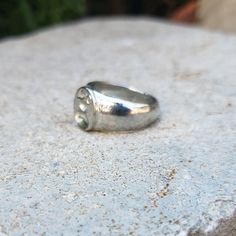 This signet ring is cast in lead-free pewter (Britannia alloy). The ring size when cast is 6.25. The sealing image is a gourd. Celestial drinking gourd. A natural/cultivated fruiting body from a vine historically used to carry beverages. This ability to help carry precious life-giving water has given the gourd special significance. This is part of a series of signet rings I am making cast from lead-free pewter. Each ring is hand sculpted to give a unique, rustic style, relief image when used as Symbolic Round Hand Cast Signet Ring, Vintage Hand Cast Signet Ring As Gift, Minimalist Hand Cast Signet Ring Gift, Minimalist Hand Cast Signet Ring For Gift, Hand-cast Silver Signet Ring, Vintage Hand-cast Round Signet Ring, Vintage Hand Cast Round Signet Ring, Hand Cast Silver Signet Ring, Vintage Nickel-free Signet Ring