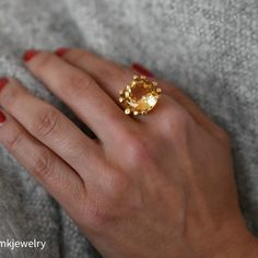 A lovely 10 carat oval citrine set in a wonderfully designed 18K yellow gold ring. The citrine is well cut has a great orangey color and is an immaculate looking stone.18K Yellow Gold Citrine 10tcw 16mm Band thickness 4.3mm Size 7.5 Resize available under request. Thank you for visiting our shop!Also, Follow us on Instagram https://www.instagram.com/dmkjewelryny/ Elegant Faceted Yellow Gold Topaz Ring, Unique Oval Yellow Gold Topaz Ring, Faceted Topaz Ring In Yellow Gold, Luxury Yellow Gold Topaz Ring Gift, Elegant Gold Topaz Ring With Polished Finish, Elegant Faceted Gold Topaz Ring, Elegant Gold Faceted Topaz Ring, Elegant Faceted Citrine Rings, Luxury Orange Topaz Round Ring