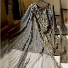 New... Never Worn Before. Gray Color Dress With Golden Work On The Shirt Piece And Duppata. Along With Banarsi Trouser. The Shirt Has Inner Lining Attach With The Kameez. Graceful Attire For Party Or Wedding Wear. Pakistani, Indian, Bangladeshi, South Asian Semi-Casual Party Wear. Measurements Shalwar (Trouser) 38 In Bust 21 Inch Waist 20 In Hips 23 In Shirt Length 37.5 In Sleeves Length 21 In Elegant Gray Long Sleeve Sets, Gray Anarkali Set With Dupatta, Festive Gray Diwali Outfit Sets, Traditional Gray Festive Sets, Gray Traditional Festive Sets, Gray Festive Sets For Diwali, Festive Gray Long Sleeve Sets, Festive Gray Sets For Eid, Gray Long Sleeve Wedding Set