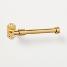 an image of a gold door handle on a white wall