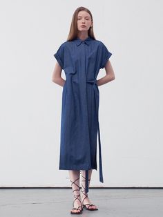 This product is a belted midi shirt dress that offers a versatile and contemporary take on the classic shirt dress. The piece features a pointed collar and a front button closure that runs the length of the dress, allowing for a customizable fit. The addition of a belt emphasizes the waist, while the midi length strikes an elegant balance between casual and formal. - The dress's side slits provide freedom of movement and a touch of allure.- Its roll-up sleeve design adds a casual, effortless look, suitable for different seasons.- The lightweight fabric ensures comfort and breathability throughout the day.- This midi shirt dress can be dressed up with heels or down with flats, making it a staple for any occasion. Collared Shirt Dress With Belted Cuffs For Work, Spring Workwear Shirt Dress With Collared Neckline, Collared Midi Dress For Summer Workwear, Summer Workwear Collared Midi Dress, Short Sleeve Midi Dress With Placket For Workwear, Summer Collared Midi Dress For Work, Collared Shirt Dress For Business Casual Summer, Summer Collared Shirt Dress For Business Casual, Chic Shirt Dress With Belted Cuffs And Spread Collar