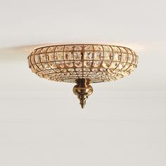 a ceiling light that is hanging from the ceiling in a room with white walls and flooring