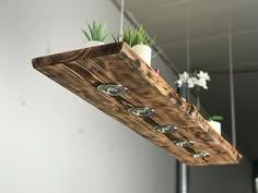 a wooden planter hanging from the ceiling