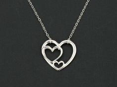 "Perfect holiday Gift. A beautiful pendant representation of grandmother, mom, and child OR father, mother, and child. OR three sisters OR best friends! Three Heart Necklace. - Delicate, high quality sterling silver chain and findings - Open heart pendent 23x 26mm - Made to order at the length you choose - Shown at 18\" on the model - Comes in a cute little package ready for gift giving. Please let me know if you want to include a custom message with your gift. { ADD ON } ♦ Lobster clasps: https Mother's Day Open Heart Nickel Free Necklace, Mother's Day Nickel-free Open Heart Necklace, Nickel-free Open Heart Necklace For Mother's Day, Mother's Day Heart Necklace Nickel Free, Mother's Day Nickel Free Double Heart Necklace, Mother's Day Double Heart Nickel Free Necklace, Mother's Day Nickel-free Double Heart Necklace, Nickel-free Double Heart Necklaces For Mother's Day, Heart-shaped Necklace For Mother's Day Wedding Gift