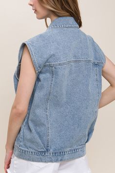 DetailsA denim vest featuring a boxy fit, collar, and functional pockets 100% cotton Trendy Sleeveless Vest With Pockets, Trendy Dark Wash Denim Vest For Work, Trendy Dark Wash Vest With Pockets, Trendy Cotton Denim Vest In Dark Wash, Trendy Dark Wash Cotton Denim Vest, Sleeveless Cotton Denim Jacket With Pockets, Casual Sleeveless Denim Jacket, Trendy Medium Wash Cotton Vest, Trendy Sleeveless Top With Pockets