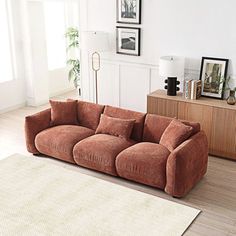 a living room filled with furniture and a rug on the floor next to a window