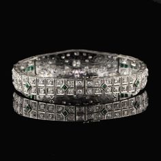 Stunning antique platinum bracelet with old european cut diamonds and emeralds. Item #B0024 Metal: Platinum Weight: 29.3 Grams Total Diamond Weight: Approximately 5.50 cts Diamond Color: H Diamond Clarity: VS2 - SI1 Measurements: 7 in x 5.5 mm Layaway: For your convenience, we will be happy to provide layaway payment options. Please contact us to work out a layaway plan which best suits your needs. All layaway purchases are final sale. All domestic and international shipments are shipped with Fe Formal White Gold Diamond Bracelet With Emerald, Emerald Diamond Bracelet In White Gold For Formal Events, Formal Silver Diamond Bracelet With Emeralds, Luxury Silver Tennis Bracelet With Emeralds, Formal Silver Tennis Bracelet With Emeralds, Formal Silver Emerald Tennis Bracelet, Silver Emerald Tennis Bracelet For Formal Occasions, Formal Emerald Diamond Bracelet With Brilliant Cut, Formal Emerald Diamond Bracelet