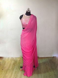 Graded pink ( light to dark) georgette embroidery saree with beautiful zardosi embroidery lines. Blouse is available as a seperate listing. The saree can be made in other colors as well Blouse: https://www.etsy.com/listing/957833251/custom-fit-graded-pink-mirror-work Festive Pink Pre-draped Saree With Mirror Work, Festive Pink Pre-draped Saree With Dori Work, Pink Chinon Sharara With Cutdana Detail, Pink Chinon Pre-draped Saree For Navratri, Designer Pink Pre-draped Saree With Zari Work, Pink Party Wear Choli With Cutdana, Pink Saree With Gota Work, Pink Dupatta With Cutdana For Party, Pink Cutdana Dupatta For Party