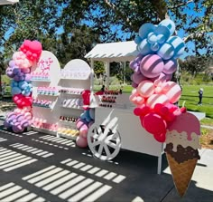 an ice cream cart decorated with balloons and streamers