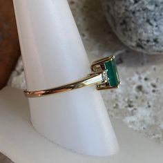 Estate/ Vintage 14KT Yellow Gold Band Ring with Center, Emerald-Cut Emerald + Diamond Accents Size: 7 Can be resized for an additional fee Genuine emerald measures: 8mm x 6mm 1/5 CTW genuine, white, round diamonds (2) total diamonds Weight: 2.8g Excellent estate condition Stunning, timeless ring with large, dark green center emerald! Emerald is the birthstone for May babies! An heirloom piece! Check out all our emerald rings + our entire jewelry collection! Please let us know if you have any que Anniversary Emerald Cut Emerald Ring With Diamond Cut, Gia Certified Emerald Ring For Anniversary, May Birthstone, Gia Certified Emerald Anniversary Ring May Birthstone, May Birthstone Princess Cut Emerald Ring In Yellow Gold, Emerald Princess Cut Diamond Ring, 14k Stamped Emerald Ring For Anniversary, Yellow Gold Emerald Cut Emerald Ring For Anniversary, Formal Emerald Ring With Diamond Cut For May Birthstone, Classic 14k Stamped Emerald Cut Emerald Ring