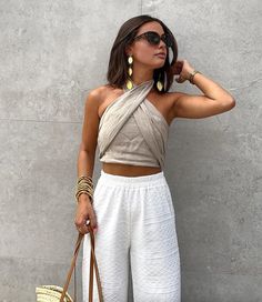 Chic Sleeveless Bandage Crop Top, Beige Halter Top For Summer Day Out, Summer Beige Halter Top For Day Out, Beige Halter Neck Top For Day Out, Beige Sleeveless Trendy Halter Top, Chic Beige Sleeveless Halter Top, Chic Bandage Tank Top For Summer, Summer Stretch Bandage Halter Top, Trendy Fitted Wrap Top For Summer