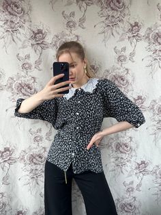 This vintage black and white floral blouse epitomizes the elegant tailoring of the 70s era. With its timeless design and sophisticated floral pattern, it exudes a sense of refined femininity. Perfectly tailored to flatter the silhouette, this women's shirt is a stylish nod to retro fashion with enduring charm. - Good vintage condition - TAG SIZE: No information  - Fabric information: 100% viscose Estimated to fit XS-S-M-L based on your desired fit. Measurements (laying flat): - Shoulders (back): Fitted Floral Print Blouse With Collared Neckline, Fitted Blouse With Floral Print And Collared Neckline, Elegant Short Sleeve Blouse With Floral Print, Chic Floral Print Blouse With Collar, Patterned Formal Tops For Spring, Black Collared Blouse With Floral Print, Elegant Short Sleeve Floral Print Shirt, Elegant Short Sleeve Floral Shirt, Fitted Printed Blouse For Workwear