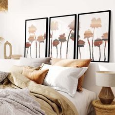 a bedroom with three pictures hanging above the bed