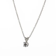 There's something classic and luxurious about a high quality single diamond hanging around your neck. This diamond solitaire pendant necklace is made from solid platinum and measures 18" long. The diamond is GIA certified as an all-natural .92ct G/VS2 round brilliant cut diamond securely set in a four prong basket style setting. This necklace comes with the GIA certificate and a free official appraisal showing the value of the necklace at $9650. Platinum Necklace With Round Pendant And Prong Setting, Classic Diamond Round Pendant Necklace, Classic Platinum Necklace With Prong Setting, Classic White Gold Diamond Necklace With Round Stone, Classic White Gold Diamond Necklace, Classic Silver Necklace With Prong Setting, Platinum Necklace With Single Diamond Pendant, Classic Single Diamond Round Cut Necklace, Wedding Platinum Solitaire Necklace With Round Pendant