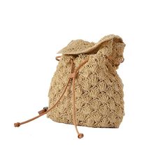 a straw bag on a white background with a brown leather strap and drawstring