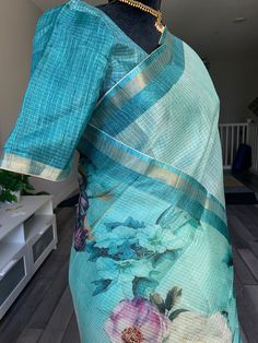 This is a beautiful Manipur Kota silk soft silk saree with floral digital prints. The saree is lightweight and easy to drape and is a cyan green shade. Bordered by a small zari patta, the saree is soft to touch and comes with tassels at the pallu and stitched blouse. Falls, pico are done and blouse is fully stitched. Size: Blouse fits sizes 36-42 inches with margins provided inside. Size 36-42 inches fully stitched blouse | Soft silk Kota silk saree in floral prints | Kota silk sarees online sho Green Saree With Digital Print For Diwali, Green Printed Saree For Wedding, Printed Chanderi Saree, Tissue Silk Blouse Piece With Floral Print, Floral Print Tissue Silk Saree, Unstitched Green Printed Saree, Green Printed Unstitched Saree, Green Chanderi Saree With Floral Print, Multicolor Floral Print Cotton Silk Saree