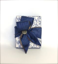 a blue and white box with a bow on it