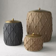 three woven storage containers with gold lids