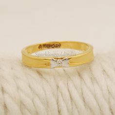 a gold ring with a diamond on it