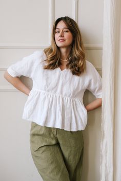 "Ruffled Linen Top is destined to cheer you up. The Peplum Top is designed in a relaxed fit complemented with a breezy raw hem and looks really airy and delicate. Being an easy fit, this white linen blouse is ideal for summer, matching the weather and the vibes. The plunging V-neck accentuates the area slimming your neck and makes it seem longer. This blouse will be a trusty attire in your wardrobe, which you can combine with various pants and shorts. DETAILS ⚬ Raw hem. ⚬ Decorated with handmade Breezy V-neck Tops With Relaxed Fit, Breezy Relaxed Fit V-neck Tops, Chic Flowy Linen Tops, Relaxed Fit V-neck Ruffle Blouse, V-neck Blouse With Ruffles And Relaxed Fit, Chic Relaxed Fit Blouse With Ruffle Hem, White Relaxed Fit Breezy Tops, Breezy Tops With Relaxed Fit For Daywear, Flowy Breezy Tops For Daywear