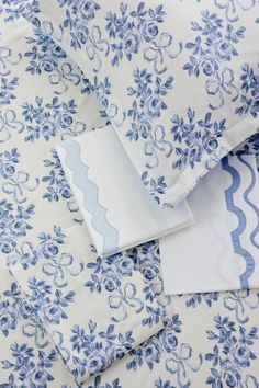 blue and white bedding with flowers on them