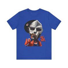 Elevate your style with our exclusive MF Doom shirt. Crafted for true hip hop fans, this tee merges comfort with swag. Embrace the vibes of this rap legends and make a statement wherever you go. This classic unisex jersey short sleeve tee fits like a well-loved favorite. Soft cotton and quality print make users fall in love with it over and over again. These t-shirts have-ribbed knit collars to bolster shaping. The shoulders have taping for better fit over time. Dual side seams hold the garment's shape for longer.  .: 100% Airlume combed and ringspun cotton (fiber content may vary for different colors) .: Light fabric (4.2 oz/yd² (142 g/m .: Retail fit .: Tear away label .: Runs true to size Hip Hop Cotton T-shirt For Streetwear, Pre-shrunk Hip Hop Tops For Streetwear, Hip Hop Tops With Sublimation Print For Streetwear, Sporty Streetwear Shirt With Sublimation Print, Pop Culture Streetwear Tops With Graphic Design, Hip Hop Cotton Tops For Streetwear, Cotton Hip Hop Tops For Streetwear, Pop Culture Graphic Design Tops For Streetwear, Hip Hop T-shirt With Graphic Design For Fans