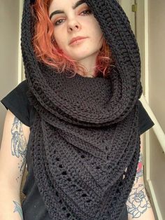 a woman with red hair wearing a black knitted shawl and looking at the camera