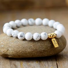 The Handmade Natural Howlite Beaded Bracelet with a Gold Plated Tag looks great. It will make the perfect gift 🎁 for someone special, or treat yourself as you deserve it 💖 🥰 These Bracelets have been made using high quality Natural Howlite and have a Gold Plated Tag with MC for MantraChakra. They are available as 4mm, 6mm and 8mm. Howlite Strengthens Memory and stimulates desire for knowledge. Howlite is a calming stone, a stone of patience and perspective and can help when you have a lot of White Gemstone Beads Bracelet As Gift, Minimalist Spacer Beads Bracelets As Gift, Minimalist Spacer Beads Bracelet As Gift, Minimalist Bracelets With Spacer Beads As Gift, Minimalist Bracelets With Spacer Beads For Gift, Classic White Beaded Bracelets As Gift, Classic White Beaded Bracelets For Gift, White Beaded Bracelets With 8mm Beads As Gift, Minimalist Beaded Bracelet With Gemstone Beads As Gift