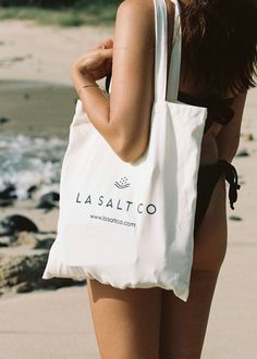 Introducing our LA SALT CO cotton tote bag - the perfect combination of style and sustainability. Crafted from premium cotton, this bag is designed to withstand heavy use while also being gentle on the environment. With ample space, it's perfect for carrying your groceries, essentials or beach necessities with ease. So make a conscious choice and say goodbye to single-use bags by switching to our eco-friendly and high-quality cotton tote bag. Eco-friendly Cotton Tote Beach Bag, Cotton Summer Beach Bag, Everyday Summer Cotton Beach Bag, Eco-friendly Large Capacity Cotton Beach Bag, Summer Style Cotton Tote Canvas Bag, Summer Style Cotton Canvas Tote Bag, Summer Cotton Tote Canvas Bag, Summer Cotton Bags For Daily Use, Summer Cotton Beach Bag For Daily Use