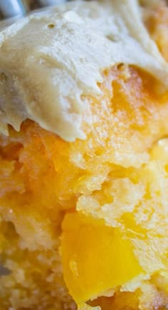 a close up of a piece of cake with icing on it and some fruit