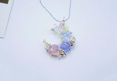 ･ﾟ✧ Why You'll Love It * Handcrafted with delicate wire-wrapping and soft pastel ombré natural gemstones (blue flash opal) and Czech glass (pink & purple glass stones) * 45 cm adjustable chain  * Ethereal crescent moon shape inspired by the magic of the night sky * Ideal for lovers of fairycore, princesscore, and celestial aesthetics * A unique gift for those who cherish romantic and fantasy-inspired jewelry ･ﾟ✧ A Celestial Dream in Pastels 🌙 Let your inner fairy queen shine with our soft paste Handmade Pastel Jewelry For Gifts, Pastel Handmade Jewelry Gift, Multicolor Moon Charm Jewelry For Jewelry Making, Whimsical Pastel Jewelry As Gift, Whimsical Adjustable Iridescent Jewelry, Whimsical Pastel Handmade Jewelry, Handmade Pastel Whimsical Jewelry, Pastel Whimsical Handmade Jewelry, Whimsical Multicolor Wire Wrapped Jewelry