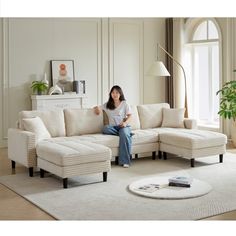 a woman sitting on top of a white couch