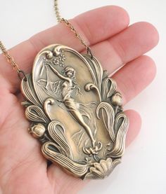 "Art Nouveau Necklace - Statement Necklace - Vintage Necklace - Vintage Brass Necklace - Goddess Necklace - handmade jewelry This is such a beautiful vintage necklace! A large brass Art Nouveau pendant hangs from a pretty vintage brass ladder chain. Incredible detail. So very bold and feminine. Chloe says, \"Wear it and feel fabulous!\" This pendant is 3 3/4\" tall and 2\" wide. You can choose the necklace length you would like at checkout. Thanks for visiting Chloe's" Artistic Bronze Collectible Necklaces, Handmade Art Nouveau Pendant Necklace, Artistic Bronze Collectible Necklace, Artistic Large Pendant Necklace For Collectors, Vintage Necklace With Antique Finish As Gift, Vintage Antique Finish Necklace As Gift, Art Deco Jewelry With Antique Finish As Gift, Vintage Antique Finish Necklace For Gift, Art Deco Antique Finish Jewelry Gift