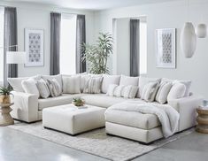 a living room with a large white sectional couch