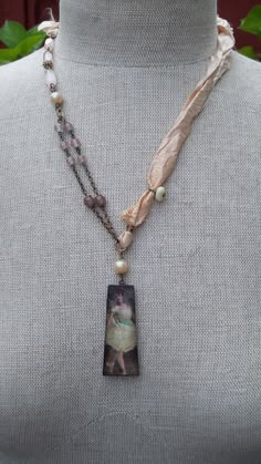 a necklace with an image of a woman on it