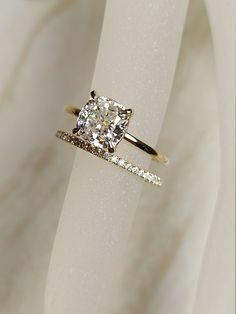 an engagement ring with a cushion cut diamond