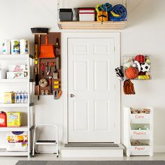 a white door in a room with shelves on the wall and toys hanging from it