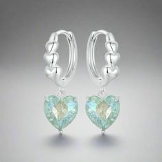 Introducing the Blue-Green Heart Dangle Hoop Earrings - crafted from 925 sterling silver, these earrings feature a charming heart dangle in a captivating blue-green shade. Here are the detailed dimensions: - Height: 23mm - Heart width: 8.5mm - Hoop inside diameter: 10.5mm These elegant earrings combine sophistication with a touch of whimsy, perfect for adding a pop of color and style to any outfit. Whether for everyday wear or special occasions, they make a lovely addition to your jewelry collection. Bridal Earrings Drop, Heart Dangle Earrings, Heart Shaped Earrings, Heart Drop Earrings, Silver Colour, Birthday Jewelry Gift, Fine Jewellery Earrings, Ear Jewelry, Heart Jewelry