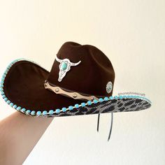 Giddy up This bedazzled cowgirl/cowboy hat is so unique! Perfect for any event such as bachelorette, wedding, quinceaneras, concerts, National Finals Rodeo, music festivals, halloween, and more!  1-Brown hat 2-Covered with diamond cut super shiny high quality crystals 3-adorned with turquoise accents including a longhorn and jewels all around the crown of the hat MANDATORY: Please indicate your hat size (S/M or L/XL) and when you need it by in the personalization section.  Follow me on Instagram Bling Cowgirl Hat, Bedazzled Cowgirl, Brown Cowgirl Hat, Country Wedding Gifts, National Finals Rodeo, Country Music Festival, Brown Hat, Festival Hat, Different Hats