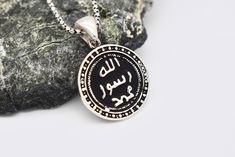 Silver Allah Name Necklace ✔Handmade Islamic necklace ✔925 sterling silver ✔Preserves its shine for a long time ✔Ready for shipping Material: 925 Sterling Silver You may choose it as a gift for him.🤍 If you have a question please don't hesitate to contact me. YOU MAY USE THE EXPRESS SHIPPING OPTION TO GET YOUR ORDER FASTER. Express shipping send by UPS, TNT, and FedEx. Delivery time: *Europe 2-4 business days, *USA- Canada 3-7 business days, *Everywhere else 5-10 business days. **Please share y Traditional Sterling Silver Coin Necklaces, Elegant Sterling Silver Necklace For Commemoration, Silver Chain Medallion Necklaces For Gifts, Traditional Pendant Jewelry For Commemoration, Medallion Necklace With Silver Chain For Gifts, Medallion Necklaces With Silver Chain For Gifts, Anniversary Amulet Sterling Silver Necklace, Anniversary Amulet Sterling Silver Necklaces, Silver Coin-shaped Engraved Necklace