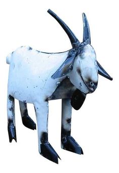 a white and black goat statue with horns on it's head, standing in front of a white background